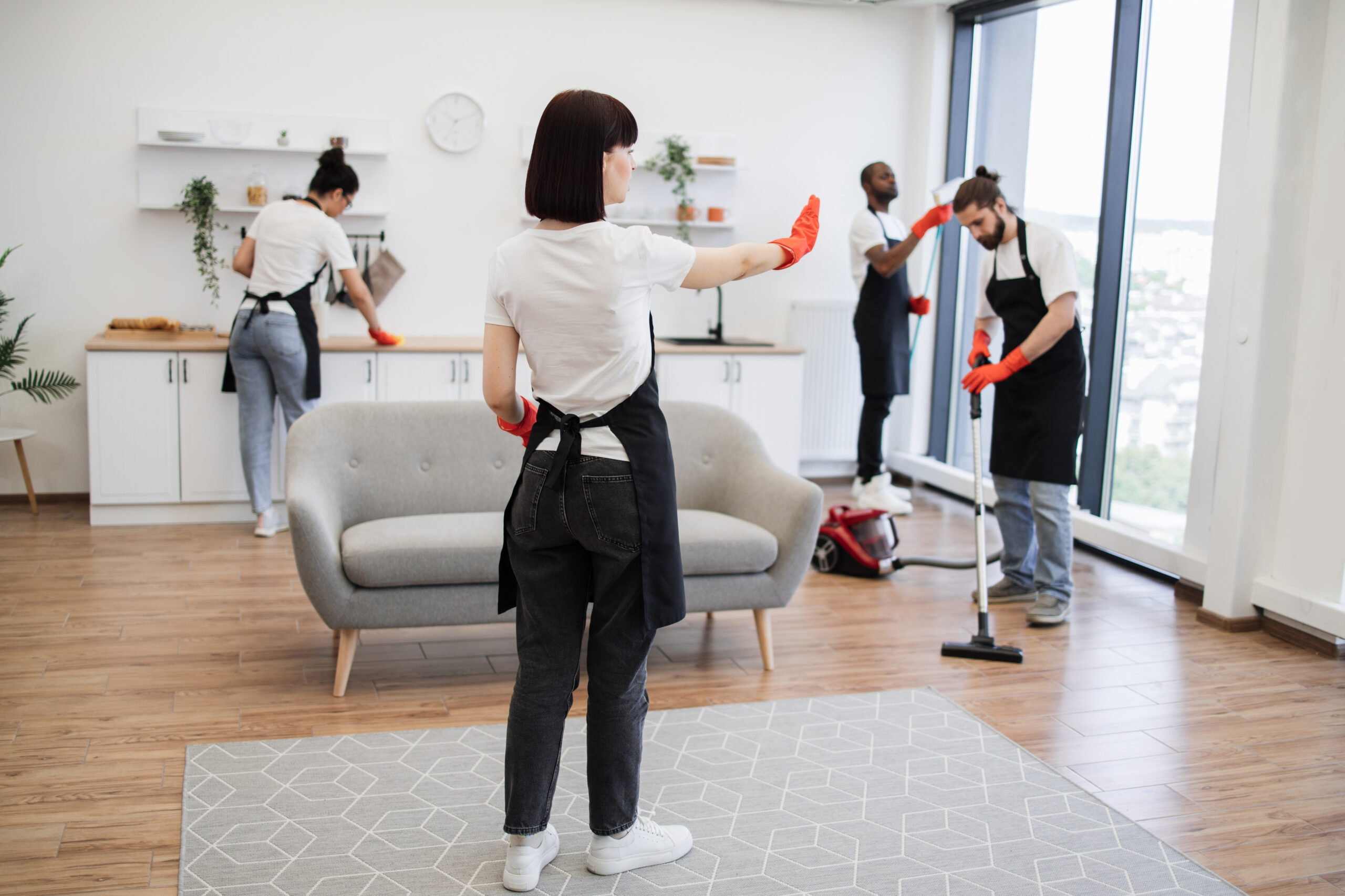 Professional cleaners working in a mostly empty Dubai home
