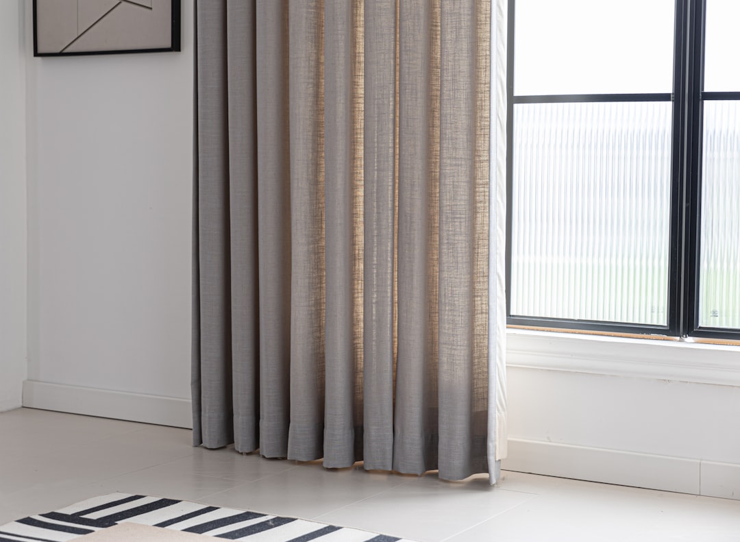 Pleated drapes in a furnished interior for professional curtain cleaning